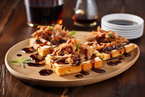 slices of crispy bread topped with carolina pulled pork and vinegar sauce