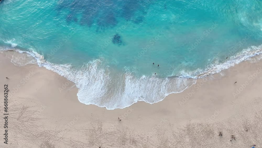 A beautiful, quiet beach with gentle waves and clear, blue sea water. at kelingking beach in nusa penida, indonesia A beautiful, quiet beach with gentle waves and clear, blue sea water. at kelingking beach in nusa penida, indonesia