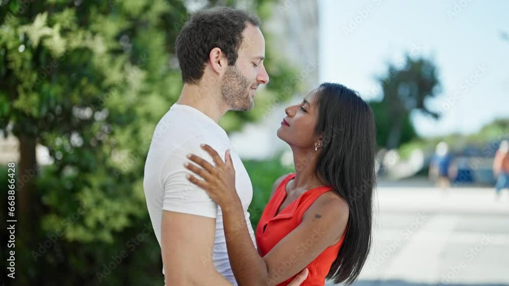 Beautiful couple smiling confident hugging each other dancing at park Beautiful couple smiling confident hugging each other dancing at park