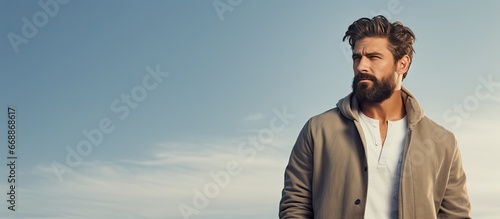 Handsome bearded man in casual clothes captured outdoors