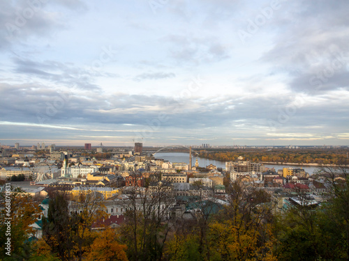 View of the Dnipro River and yellow trees in the center of the city. Historical architecture and landscape  nature of Kyiv. The city center of Kyiv  Ukraine in autumn. Beautiful sky.