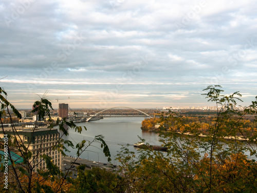 Downtown of Kyiv, Ukraine in autumn. Views of historic architecture and landscape, nature of Kyiv. Dnipro river and yellow trees in the city center.