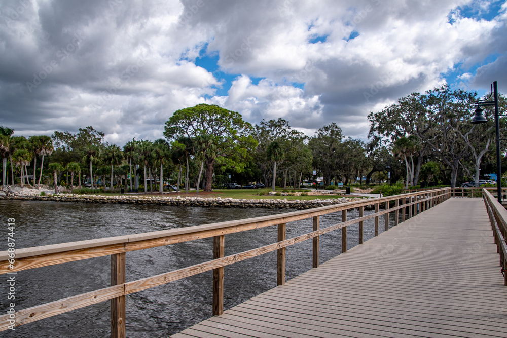 Scenes along Bradenton Florida Riverwalk East, boardwalk, wooden pier, structures, park and nature scenes, wooden observation tower, Manatee River. Blue skies white full clouds. Florida nature scene
