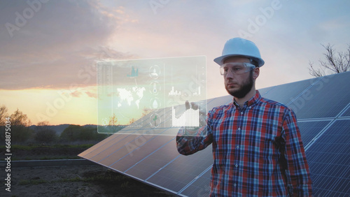 Engineer in front of solar panel works on futuristic table HUD display. Graphics