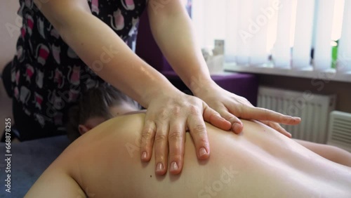 Wallpaper Mural Beautiful young brunette woman gets hot stones massage at day spa. Attractive female relaxing at spa center with a stone therapy. Healthy lifestyle and body care concept Torontodigital.ca