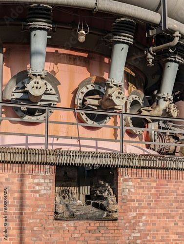 Obraz na płótnie Close up view of industrial blast furnace lower part: bustle pipe which supplies the blast (hot gas) to the tuyeres; and a tap hole through which molten metal, matte, or slag can be tapped. w salonie