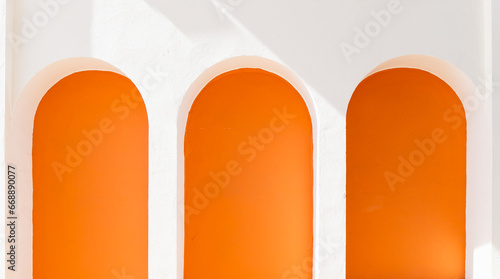 Three white and orange arches, architectural detail in Marbella city, Spain.