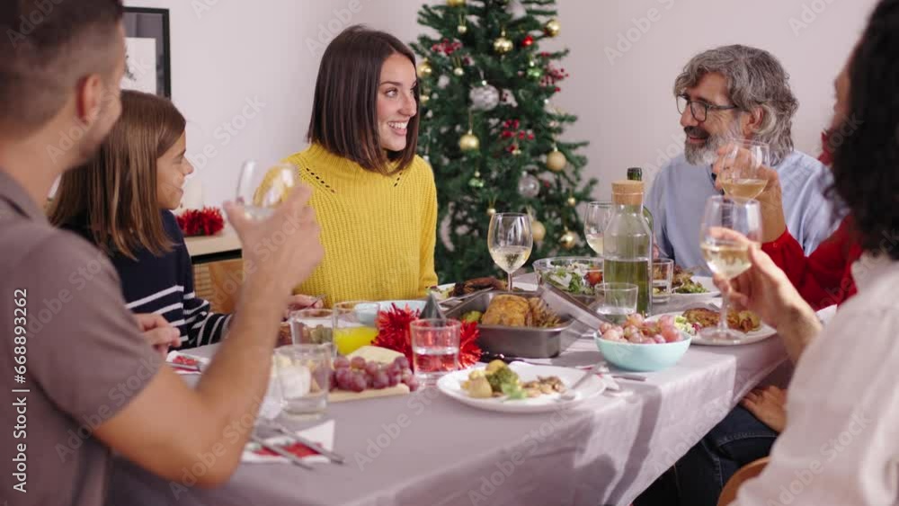 Happy Caucasian multi-generational family having fun celebrating Christmas at home gathered around festive table having roast turkey meal and enjoying winter vacation season and their time together. Happy Caucasian multi-generational family having fun celebrating Christmas at home gathered around festive table having roast turkey meal and enjoying winter vacation season and their time together.