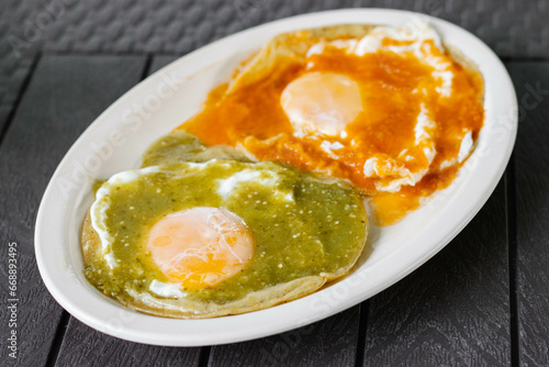 Huevos divorciados con salsa verde y roja  photo