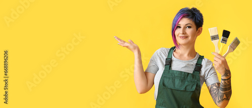 Female decorator holding br...