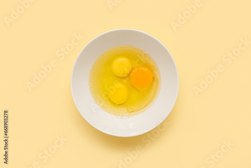 Three raw eggs with two yel...