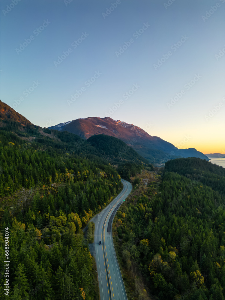 Sea to Sky Highway on West Coast of Pacific Ocean. Aerial Mountain Landscape. Twilight sky.