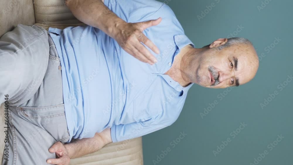 Vertical video of The old man criticizes what he sees on TV. Vertical video of The old man criticizes what he sees on TV.