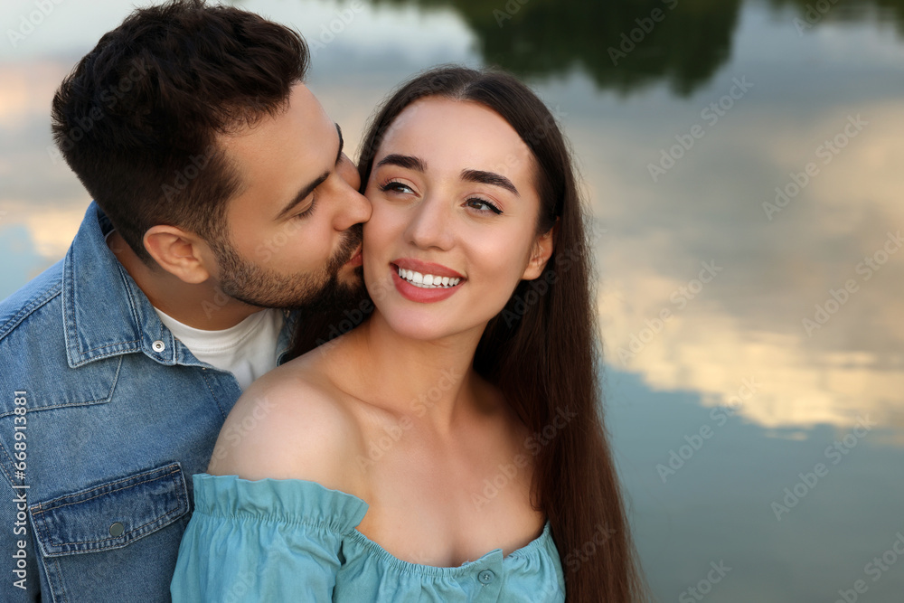 Romantic date. Beautiful couple spending time together near lake Romantic date. Beautiful couple spending time together near lake