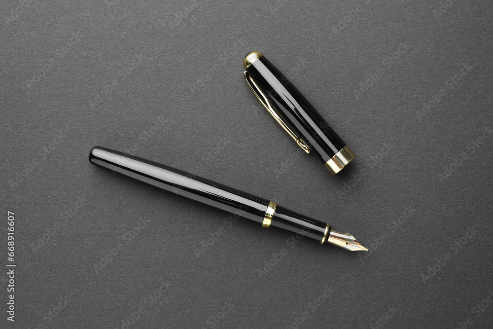 Stylish fountain pen with cap on dark background, flat lay Stylish fountain pen with cap on dark background, flat lay