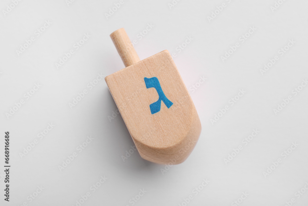 Wooden dreidel on white background, top view. Traditional Hanukkah game Wooden dreidel on white background, top view. Traditional Hanukkah game