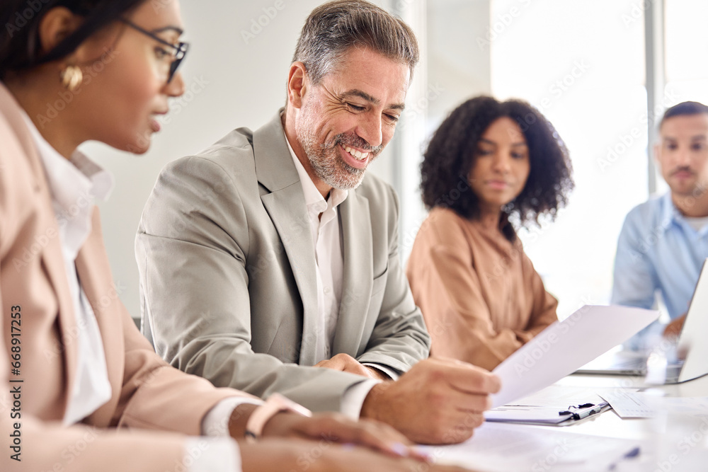 Fototapeta premium Happy senior older Indian businessman investor bank client checking document at office team meeting with financial law experts attorneys team. Consultancy and advisory services concept.