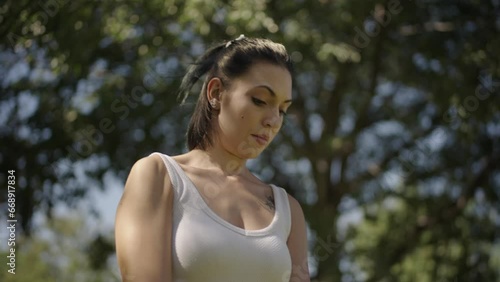 young Spanish woman exercising her body with elastic bands in a park in her city