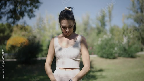 young Spanish woman exercising her body with elastic bands in a park in her city