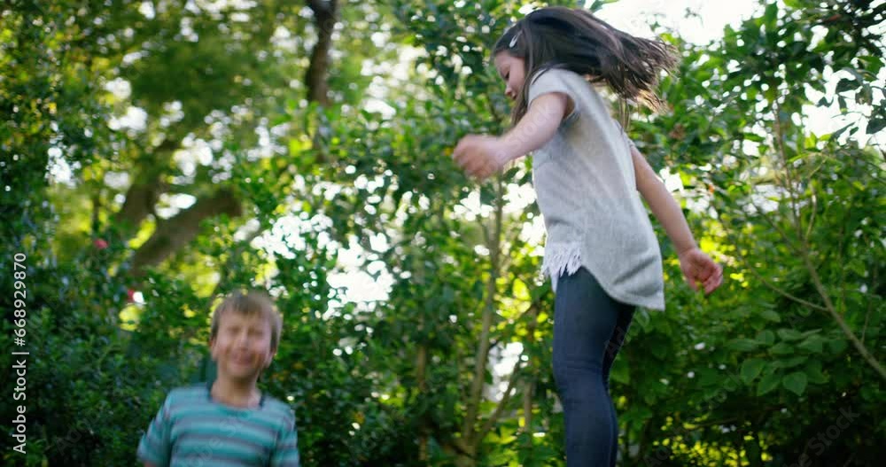 Trampoline, happy or children play in backyard for fun games on holiday to relax together. Wellness, bounce or excited kids in nature or kindergarten for jumping game, playing or activity for freedom Trampoline, happy or children play in backyard for fun games on holiday to relax together. Wellness, bounce or excited kids in nature or kindergarten for jumping game, playing or activity for freedom