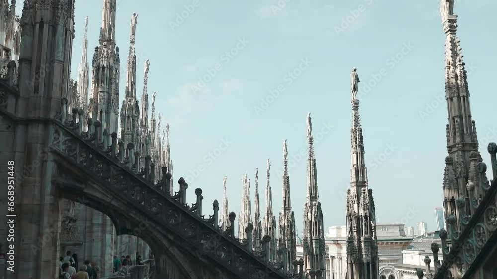 Milan Cathedral roof on sunny day, Italy. Milan Cathedral or Duomo di Milano is top tourist attraction of Milan. Amazing view of old Gothic spires. Nice rooftop terrace of famous Milan landmark. High Milan Cathedral roof on sunny day, Italy. Milan Cathedral or Duomo di Milano is top tourist attraction of Milan. Amazing view of old Gothic spires. Nice rooftop terrace of famous Milan landmark. High