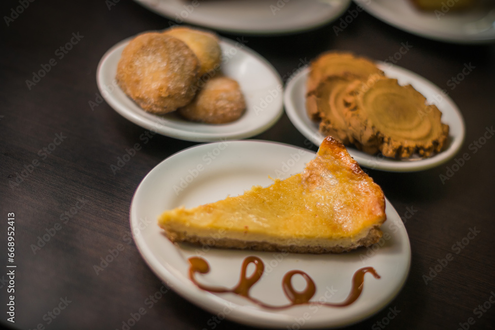 Variety of pieces of cakes and cookies on a table Variety of pieces of cakes and cookies on a table