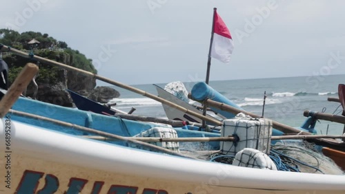 A traditional fishing boat with the iconic red and white flag of Indonesia, symbolizing the nation's maritime heritage.
