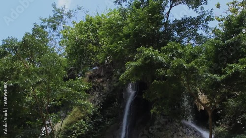 A video waterfall surrounded by lush greenery, offering a serene and natural escape.