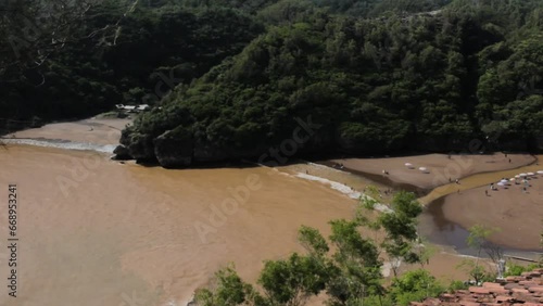 The video sof  Gunungkidul Beach name Baron in Indonesia, renowned for its white sandy shores, clear waters, limestone cliffs, and serene atmosphere, making it a perfect for nature lovers