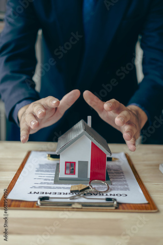 Hands-on protection on small house mortgage loans, property management Investment and Risk Management Family and home insurance man in shirt