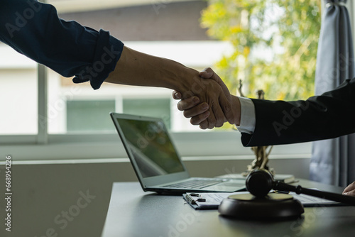 A lawyer shakes hands with a businessman to close a deal with a lawyer to discuss the contractual terms of the agreement. In the contract. Close-up photo. photo