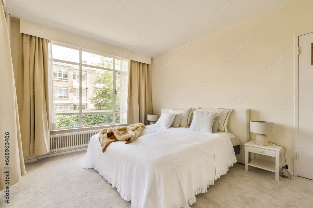 a bedroom with a bed, window and rugs on the floor in front of the bed is a teddy bear