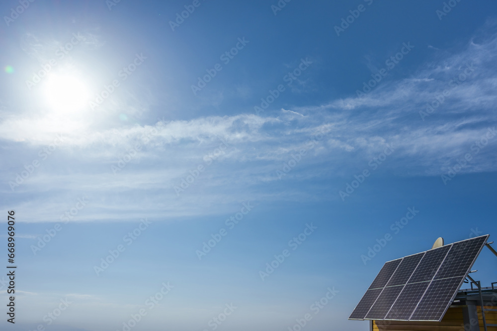 Photovoltaic modules on the roof of a house on a sunny day Photovoltaic modules on the roof of a house on a sunny day