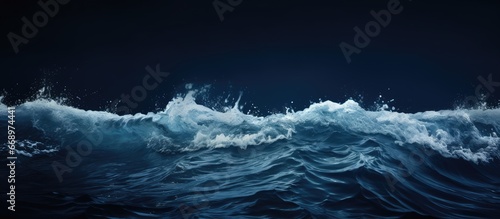Photograph of the stunning foamy dark sea water surface captured horizontally in color