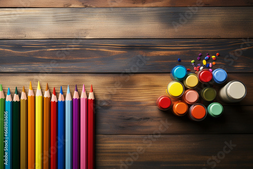 Colorful pencils and paints on wooden table. Back to school