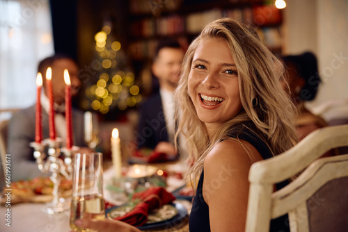 Cheerful woman on New Year s dinner party looking at camera.