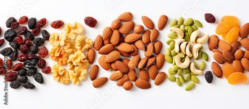 Vegetarian food concept Variety of dried fruits nuts and seeds on white background Overhead view Closeup of mixed nuts set