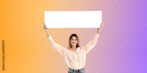 Young woman standing with blank mock up signboard, gradient background