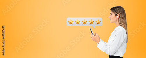 Happy woman with phone and five star rating