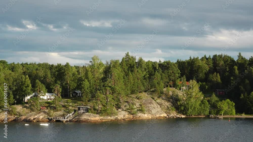 Stockholm Archipelago. Swedish archipelago nature on sunny day in summer. Green forest trees at shoreline. Sweden nature. Forest on island in the Stockholm archipelago, Baltic Sea Stockholm Archipelago. Swedish archipelago nature on sunny day in summer. Green forest trees at shoreline. Sweden nature. Forest on island in the Stockholm archipelago, Baltic Sea