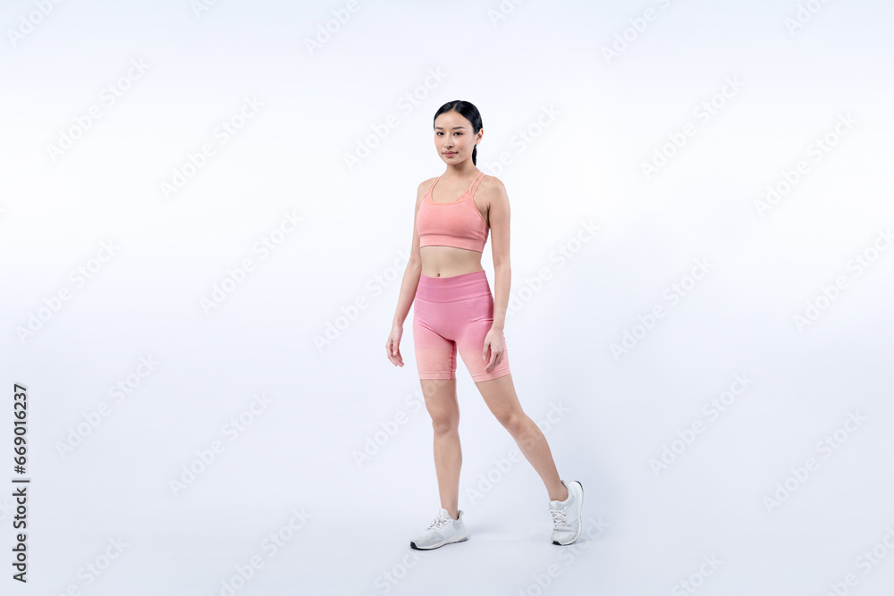 Full body asian woman in sportswear portrait, smiling and posing cheerful gesture. Workout training with attractive girl engage in her pursuit of healthy lifestyle. Isolated background Vigorous