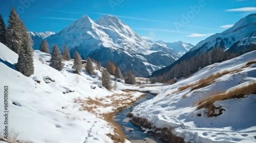 Beautiful snowy mountain in the alps with trees on a sunny day.