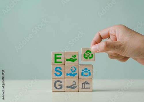 ESG concepts regarding environment, society and governance Sustainable organizational development Wooden cube handle with renewable energy Standing with other ESG icons