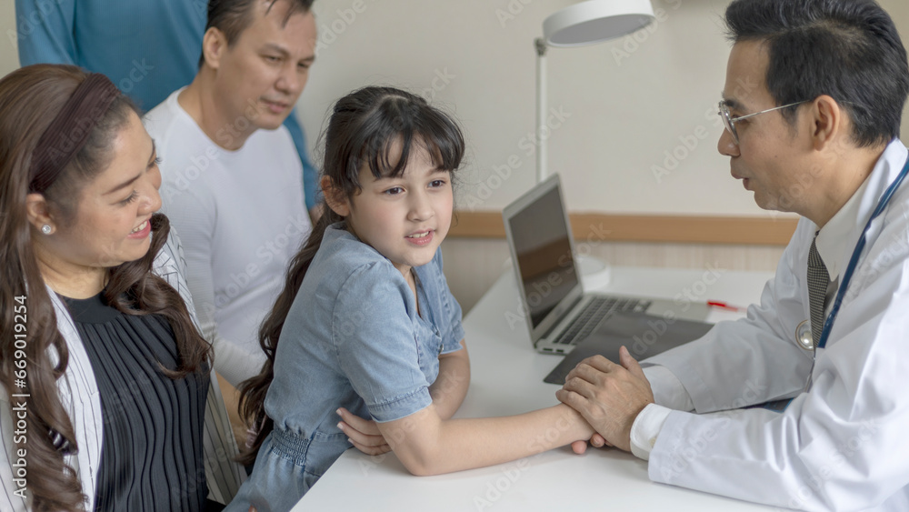 A girl gets good care from a male doctor by holding his hand with feeling good and listening the result from her diagnosis. Doctor takes care his patient with warm hospitality. A girl gets good care from a male doctor by holding his hand with feeling good and listening the result from her diagnosis. Doctor takes care his patient with warm hospitality.