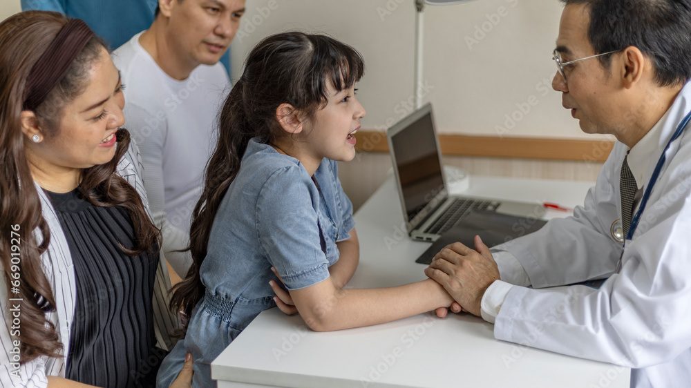 A girl gets good care from a male doctor by holding his hand with feeling good and listening the result from her diagnosis. Doctor takes care his patient with warm hospitality. A girl gets good care from a male doctor by holding his hand with feeling good and listening the result from her diagnosis. Doctor takes care his patient with warm hospitality.