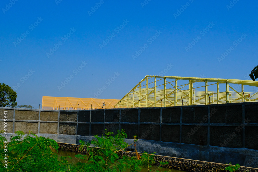 Industrial Photography. A roof frame of a factory under construction. Textile factory, iron frame, construction industry, factory construction, Bandung - Indonesia