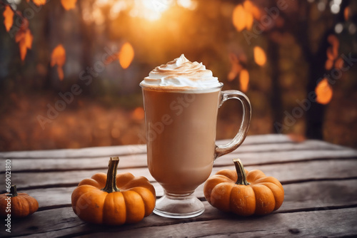still life of a cup of hot latte and pumpkins on an old wooden table against the background of beautiful autumn nature at sunset, decoration for Halloween