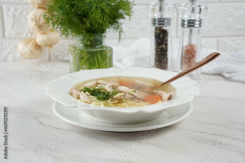 Chicken soup, chicken broth, with pieces of chicken and vegetables. Chicken bouillon, boiled meat