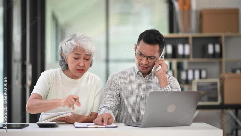 Furious two Asian businesspeople arguing strongly after making a mistake at work in office Furious two Asian businesspeople arguing strongly after making a mistake at work in office