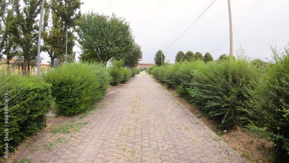 footpath paved with tiles leaving Fiorenzuola d'Arda city, province of Piacenza, Emilia-Romagna, Italy footpath paved with tiles leaving Fiorenzuola d'Arda city, province of Piacenza, Emilia-Romagna, Italy